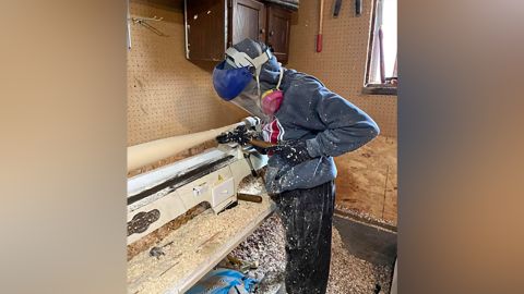 Rhomberg carving one of his homemade bats.