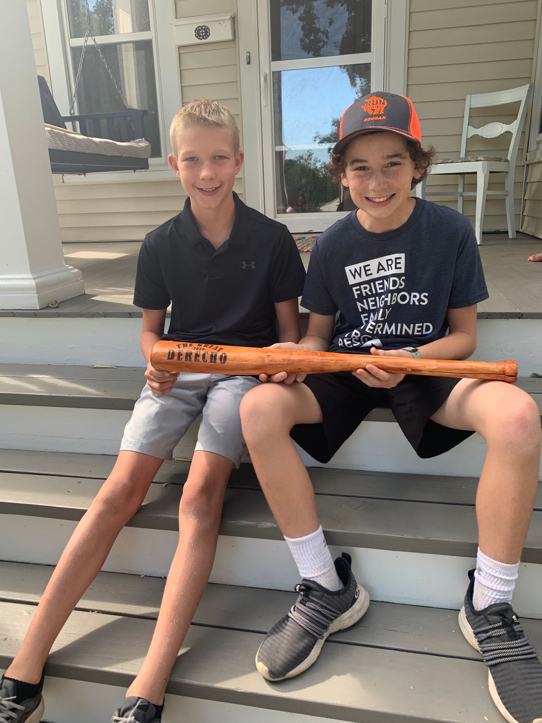 Tommy Rhomberg, right, and Walker Viessman hold the bat Tommy made for Walker.