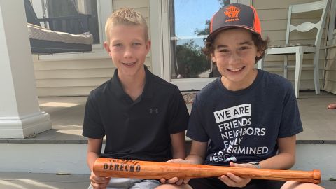 Tommy Rhomberg, right, and Walker Viessman hold the bat Tommy made for Walker.