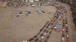 TOPSHOT - This aerial view shows people waiting in line in their cars at a Covid-19 testing site at Dodger Stadium in Los Angeles, California, November 18, 2020. - As case numbers spike health officials are warning that Los Angeles county is facing "one of the most dangerous moments in this pandemic," and are defending new, stricter business and social gathering restriction, including a curfew which will require restaurants, breweries, bars and non-essential retail businesses to be closed from 10pm to 6am. (Photo by Robyn Beck / AFP) (Photo by ROBYN BECK/AFP via Getty Images)