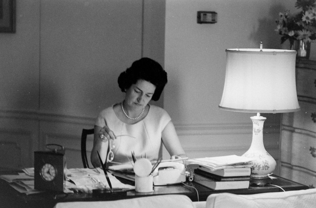 Lady Bird Johnson sits at a White House table in 1964.