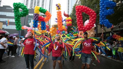 Employees from a local business support LGBTQ rights march during the city's annual Gay Pride parade on Sunday, October 13, 2019, in Atlanta.