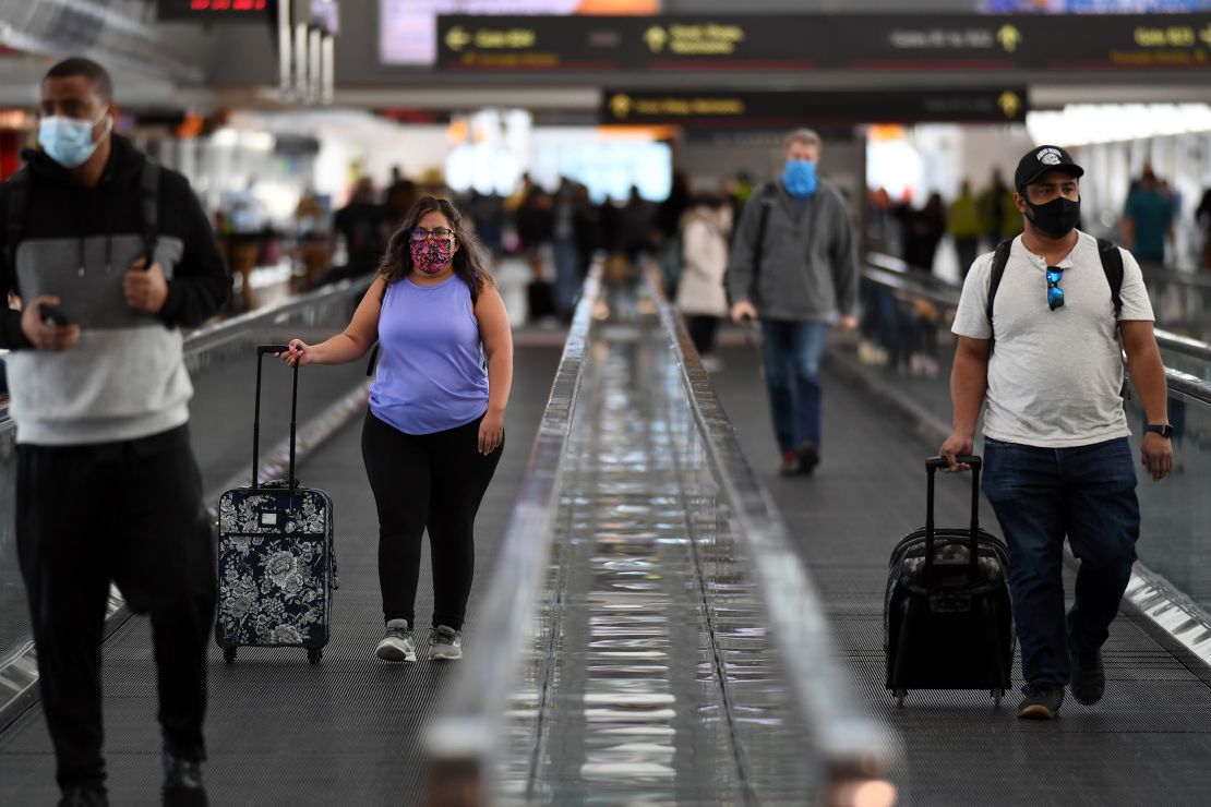 Travelers at Denver International Airport on Friday. More than 1 million people were screened by TSA at US airports on Friday despite warnings urging people not to travel due to rising Covid-19 cases.