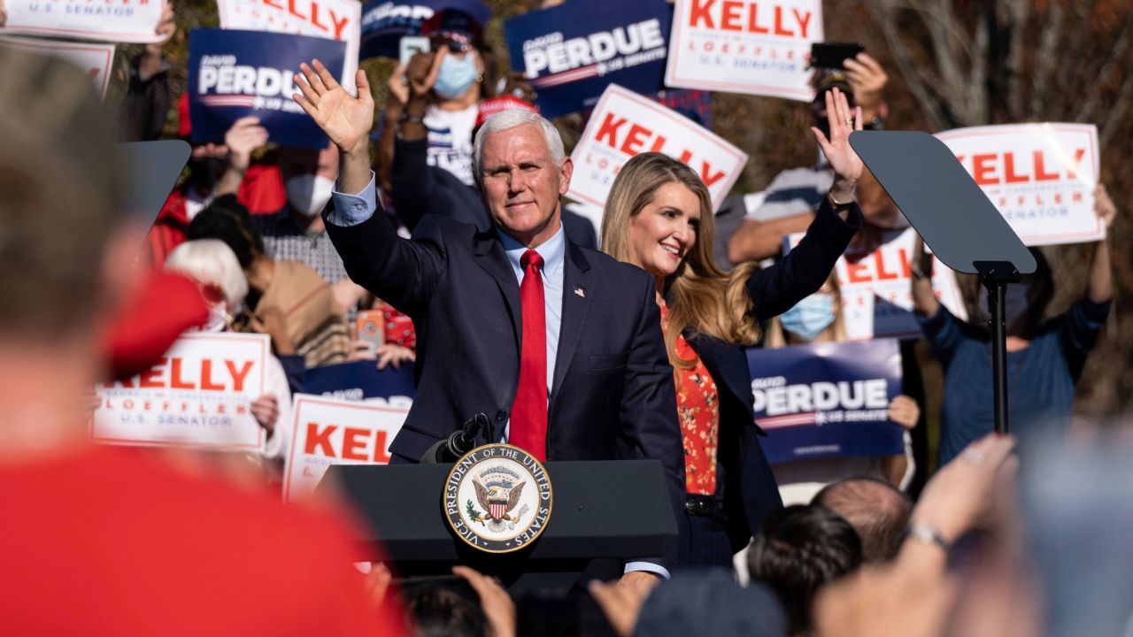 Vice President Mike Pence and Georgia Sen. Kelly Loeffler wave to the crowd during a Defend the Majority Rally, in Canton, Georgia, on November 20, 2020.