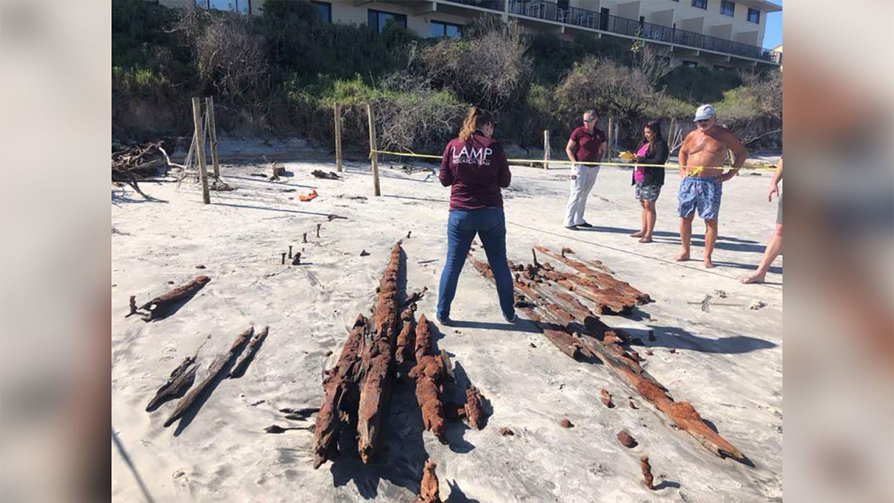 Researchers examine the timbers from the shipwreck.