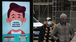 People on the streets of Toronto wear masks as the city moves towards another lockdown to slow the spread of the COVID-19.