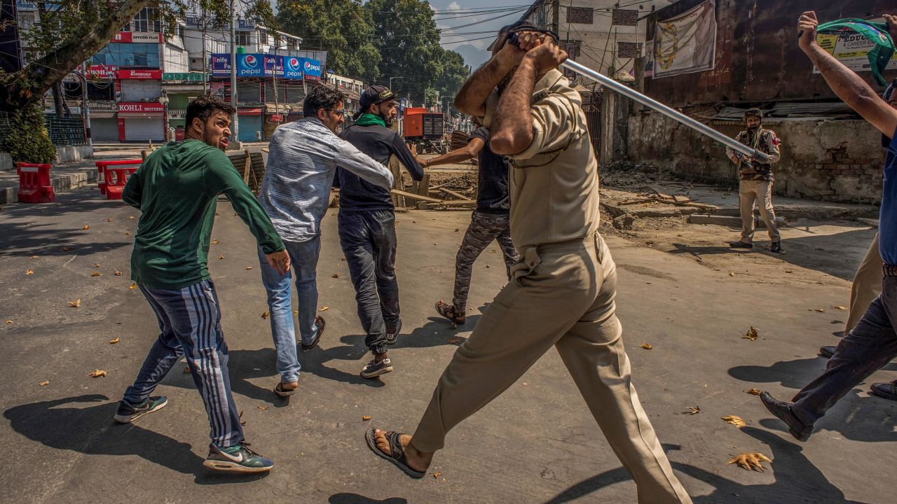 SRINAGAR, KASHMIR, INDIA - SEPTEMBER 08:  Indian policeman beat and detain Kashmiri Shiite mourners during curfew like restrictions in the city center on September 08, 2019 in Srinagar, the summer capital of Indian administered Kashmir, India. Dozens of Shiite Muslim mourners were detained by Indian police as they tried to take part in the procession during Muharram, the first month of Islamic lunar calendar. Muslims mourn the slaying of the Prophet Mohammed's grandson Imam Hussain, who was assassinated by his political rivals along with 72 companions in 680 AD in Iraq. India has banned any processions and similar public gatherings in Kashmir after a rebellion against Indian rule broke out in 1989. (Photo by Yawar Nazir/ Getty Images)