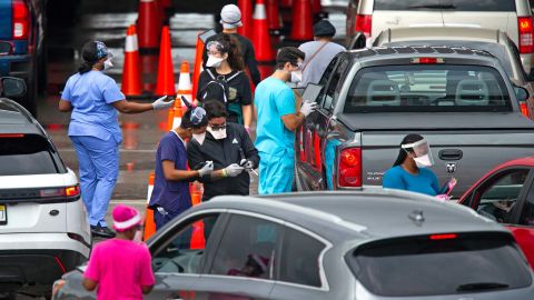 Vehicles line up as health care workers help to check in people being tested at the Covid-19 drive-thru testing center at Hard Rock Stadium in Miami Gardens, Florida, on Sunday.