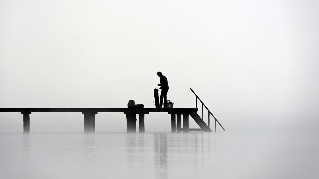 <strong>Stegen, Germany:</strong> A man stands in heavy fog on a cold winter day on a pier at Lake Ammersee in southern Germany. <br />