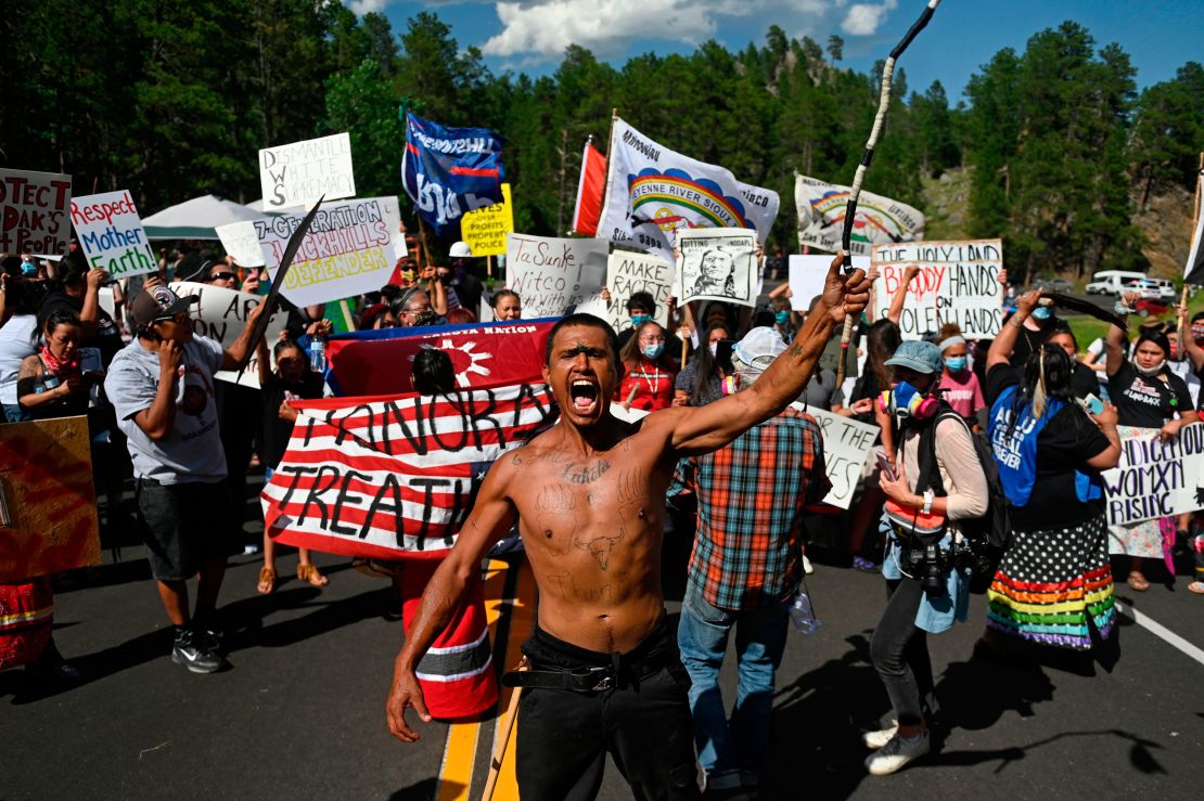 Activists and tribal citizens block the road to Mount Rushmore National Monument during a protest on July 3, 2020.