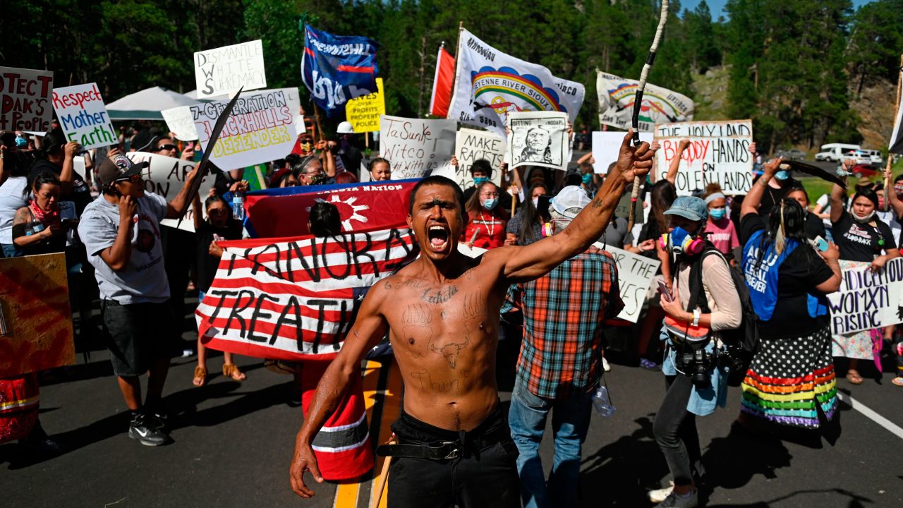 Activists and tribal citizens block the road to Mount Rushmore National Monument during a protest on July 3, 2020.