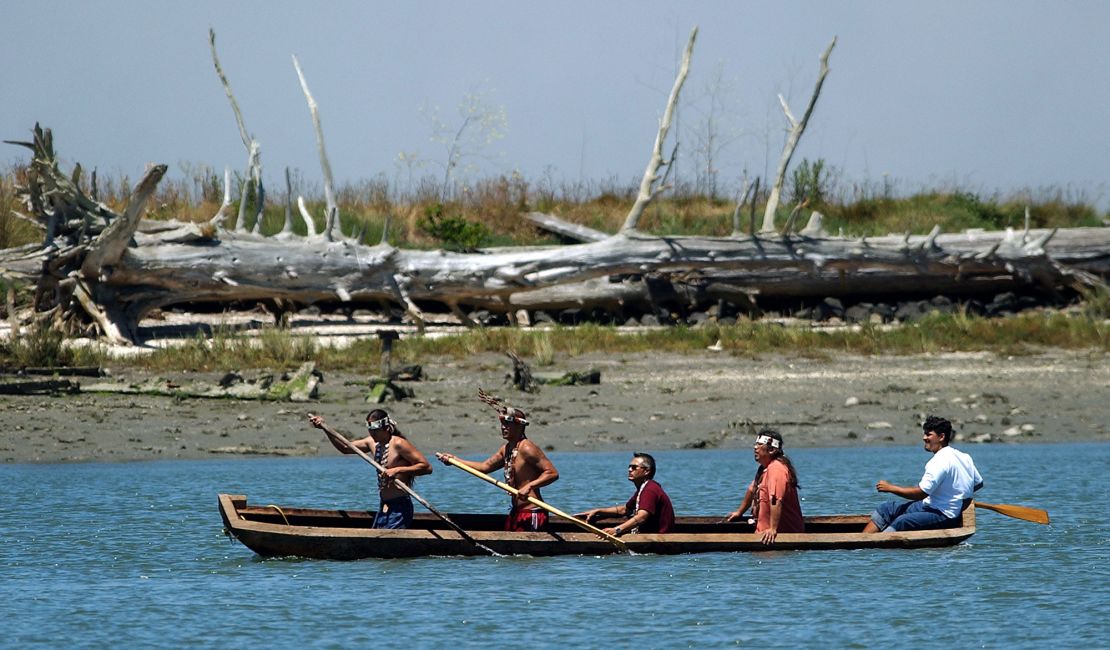Members of the Wiyot tribe paddle a canoe from Duluwat Island across Humboldt Bay on June 25, 2004.