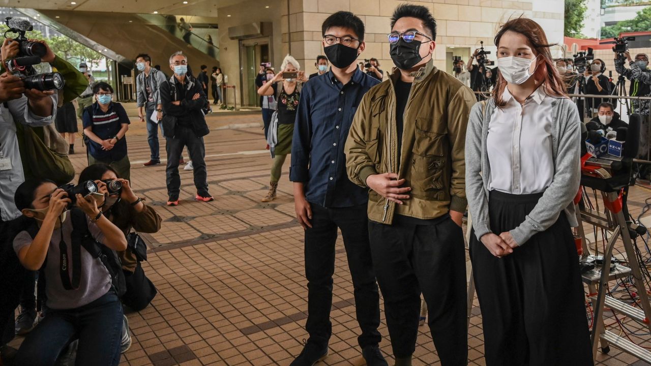 Joshua Wong, Ivan Lam and Agnes Chow arrive for their trial at West Kowloon Magistrates Court in Hong Kong on November 23, 2020.