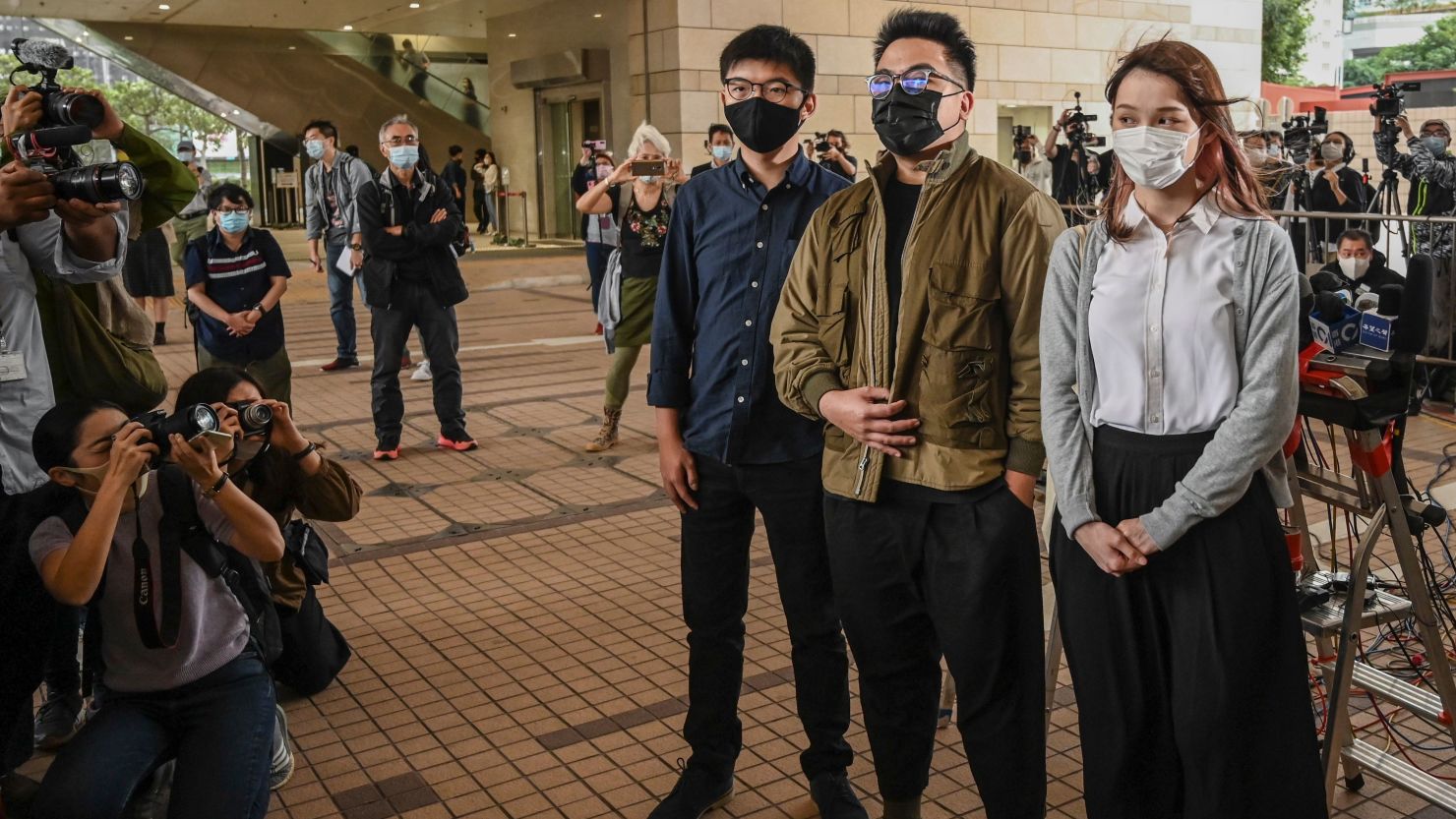 Pro-democracy activists Joshua Wong, Ivan Lam and Agnes Chow arrive for their trial at West Kowloon Magistrates Court in Hong Kong on November 23, 2020.