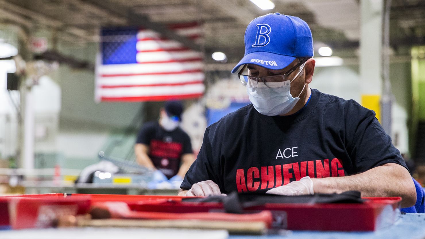 A worker wearing a protective mask and gloves assembles face shields at the Cartamundi-owned Hasbro manufacturing facility in East Longmeadow, Massachusetts, U.S., on Wednesday, April 29, 2020. 
