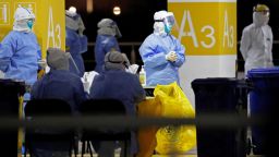This photo taken on November 22, 2020 shows health workers in protective suits waiting to conduct COVID-19 coronavirus tests on staff at Pudong Airport in Shanghai. (Photo by STR / CNS / AFP) / China OUT (Photo by STR/CNS/AFP via Getty Images)