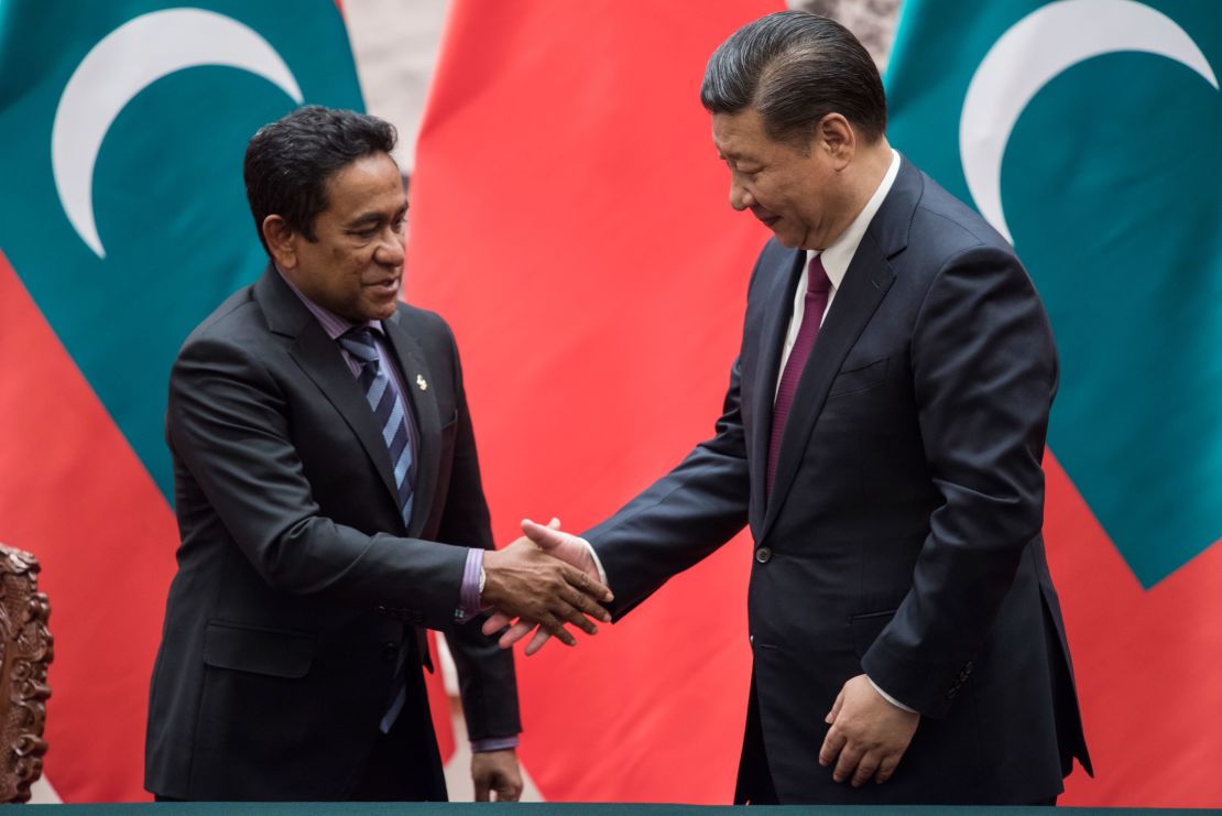 Former Maldives President Abdulla Yameen (L) shakes hand with Chinese President Xi Jinping after a signing ceremony at the Great Hall of the People in Beijing in December 2017.