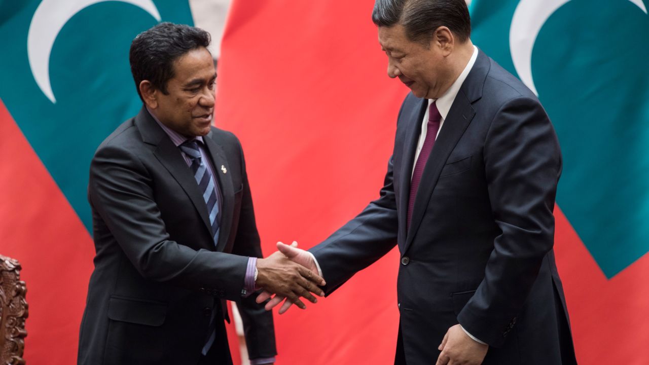 Former Maldives President Abdulla Yameen (L) shakes hand with Chinese President Xi Jinping after a signing ceremony at the Great Hall of the People in Beijing in December 2017.