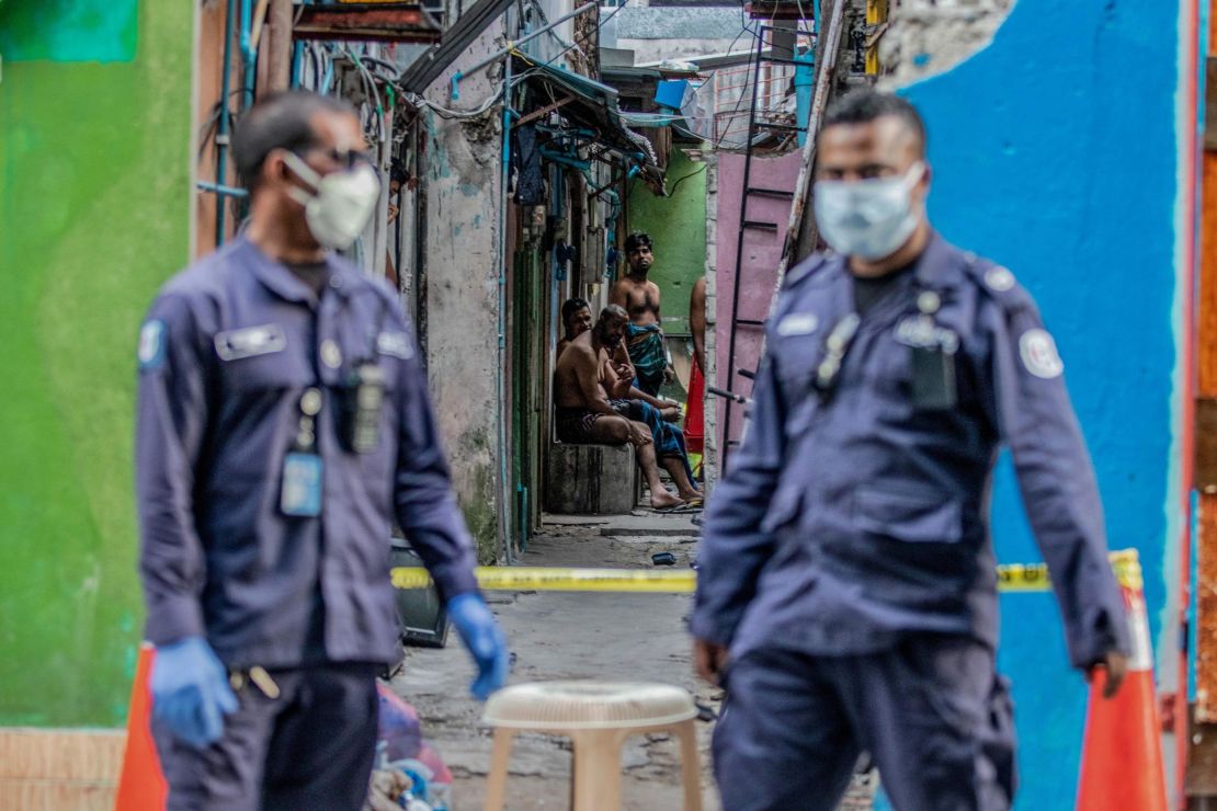 Security personnel in Malé stand guard outside a residential area for Bangladeshi workers, who were placed under coronavirus quarantine in May.