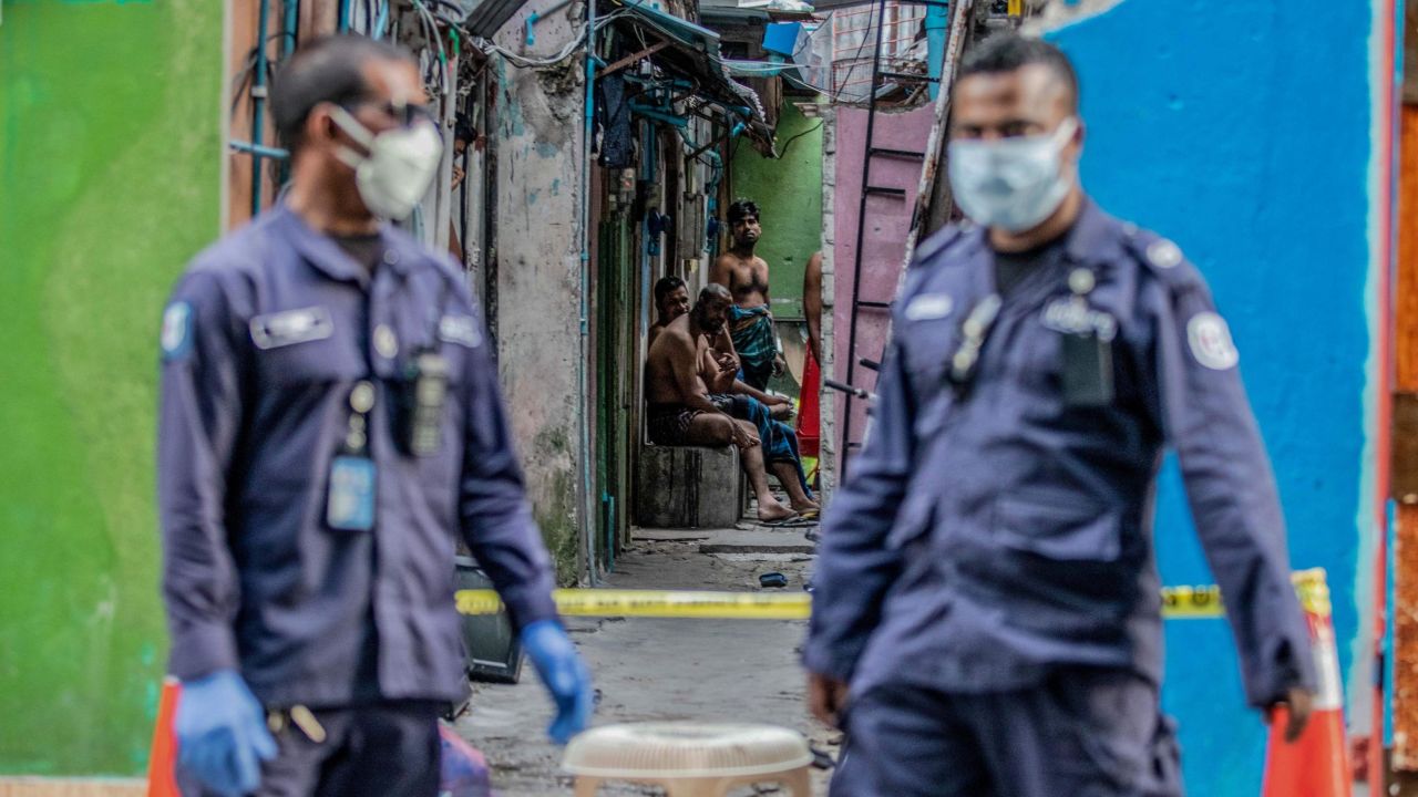 Security personnel in Malé stand guard outside a residential area for Bangladeshi workers, who were placed under coronavirus quarantine in May.