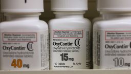 Bottles of Purdue Pharma L.P. OxyContin medication sit on a pharmacy shelf in Provo, Utah, U.S., on Wednesday, Aug. 31, 2016. A Nov. 2015 forecast from health data firm IMS Health expects global sales of brand and generic prescription drugs, and nonprescription medicines, to total $1.4 trillion in 2020. Photographer: George Frey/Bloomberg via Getty Images