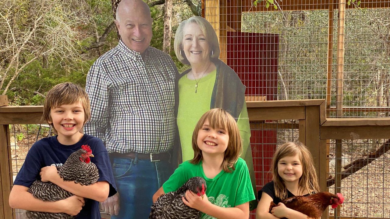 Quinton, Oliver and Clara Buchanan (l-r) have enjoyed posing for photos with the cutout of their grandparents.