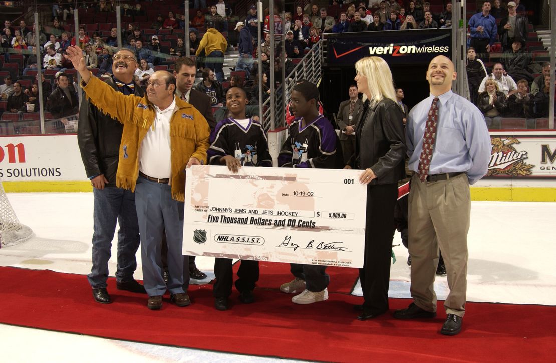 Fred Sasakamoose reacts as he is presented with a check for Johnny's Jems and Jets Hockey team during a ceremony celebrating at the United Center on October 19, 2002 in Chicago, Illinois. 