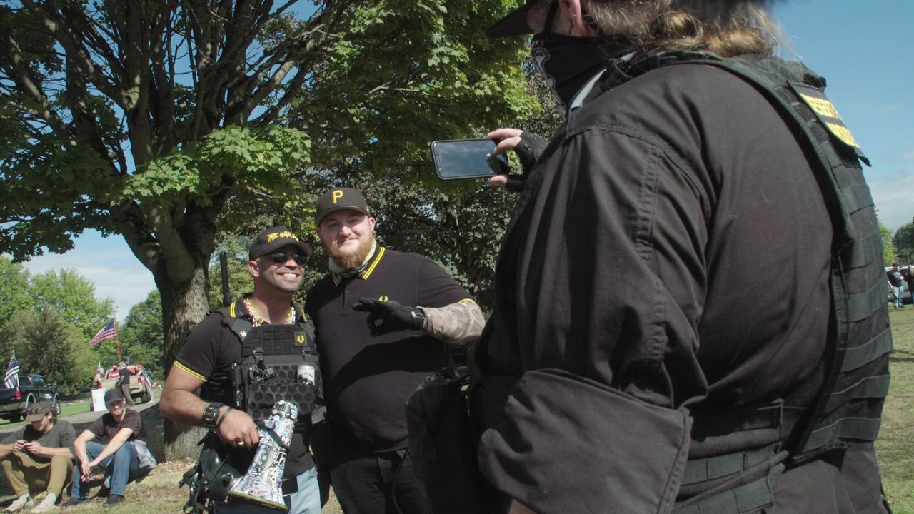 Proud Boys chairman Enrique Tarrio poses with a Proud Boys member at a rally in Delta Park in Portland, Oregon, on September 26, 2020.