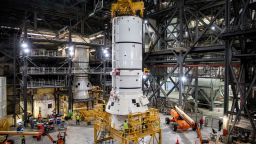 The aft segments of the Space Launch System solid rocket boosters for the Artemis I mission prepares to move from high bay 4 inside the VAB for stacking on the mobile launcher inside high bay 3.