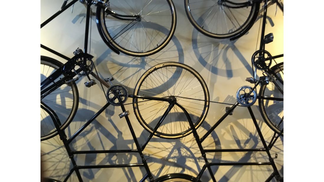A bicycle installation hangs on a museum wall. "Most of my work is with light, shadow and shape," says Lal.
