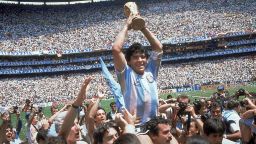 FILE - In this June 29, 1986 file photo, Diego Maradona holds up his team's trophy after Argentina's 3-2 victory over West Germany at the World Cup final soccer match at Atzeca Stadium in Mexico City. The Argentine soccer great who was among the best players ever and who led his country to the 1986 World Cup title before later struggling with cocaine use and obesity, died from a heart attack on Wednesday, Nov. 25, 2020, at his home in Buenos Aires. He was 60. (AP Photo/Carlo Fumagalli, File)