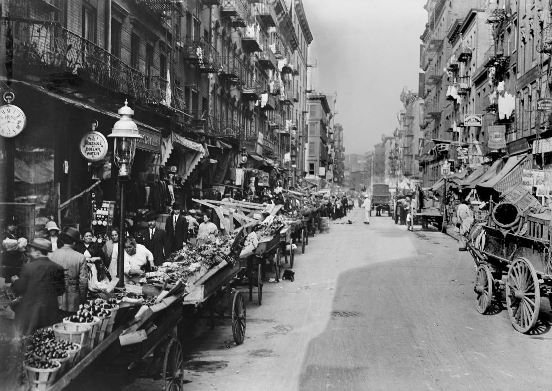 1900: An Italian neighborhood street market on Mulberry Street in New York City. 