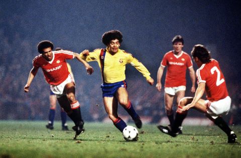 Maradona, playing for Barcelona, dribbles past Manchester United players in 1984.