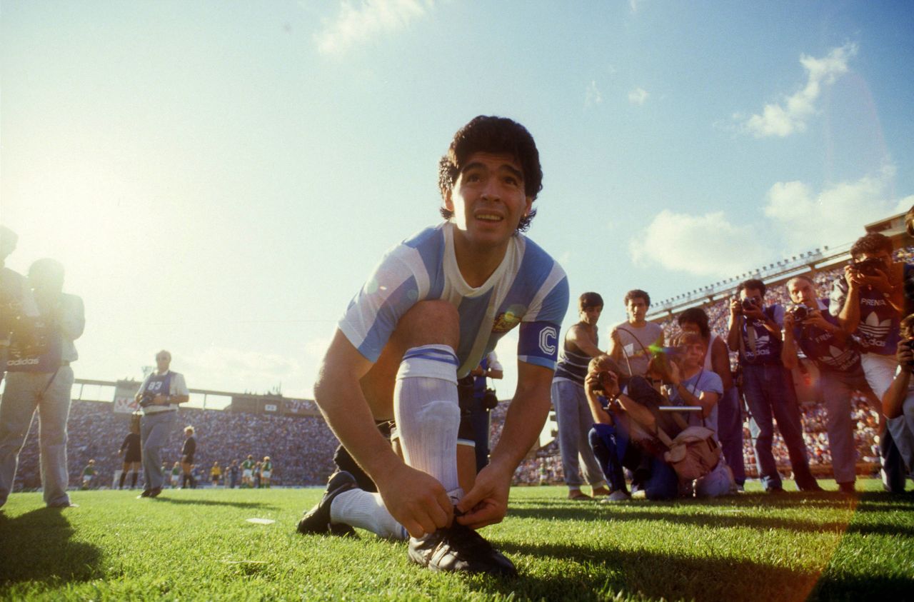 Maradona ties his shoelaces before a friendly game against West Germany in 1987.