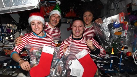 (From left) Meir, Parmitano, Morgan and Koch celebrate Christmas in space -- in matching pajamas.