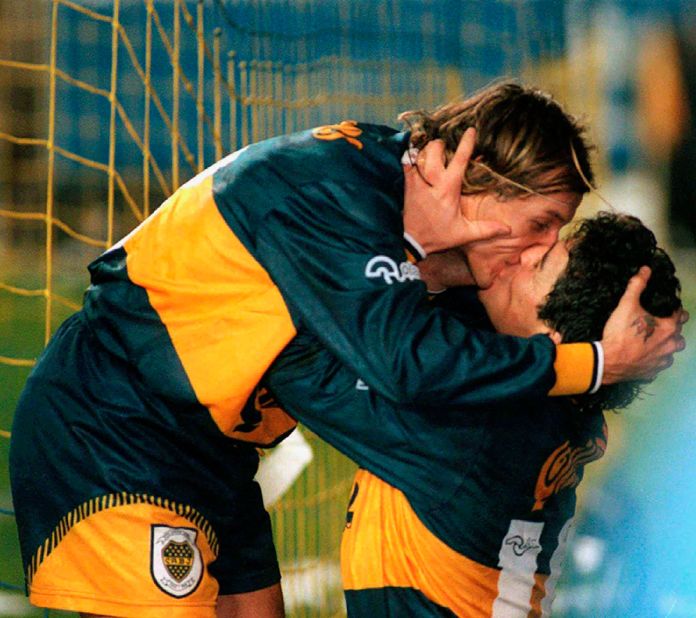 Maradona kisses his Boca Juniors teammate Claudio Caniggia after a goal against rival River Plate in 1996. Maradona finished out his playing career at Boca, where he starred in the early 1980s before moving to Europe.