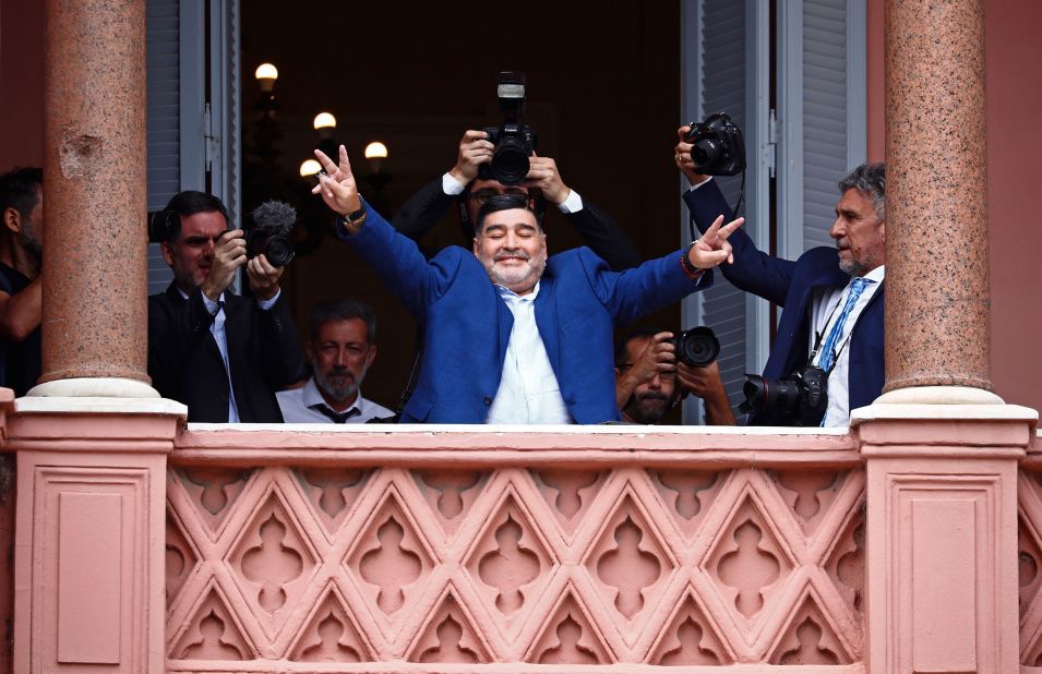Maradona greets fans outside the Casa Rosada government house after meeting with Argentine President Alberto Fernandez in 2019.