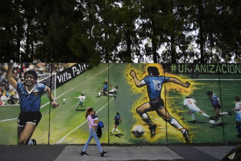 A woman walks past a Maradona mural in San Justo, Argentina, in October 2020.