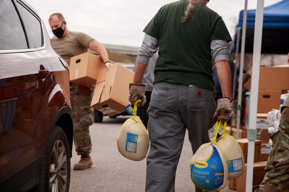 Members of the Indiana National Guard assist food bank volunteers as they distribute Thanksgiving meals in Bloomington, Indiana, on November 20.