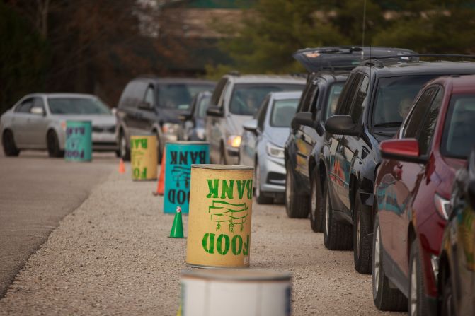 Cars line up as the Pantry 279 food bank hands out Thanksgiving meals in Bloomington, Indiana.