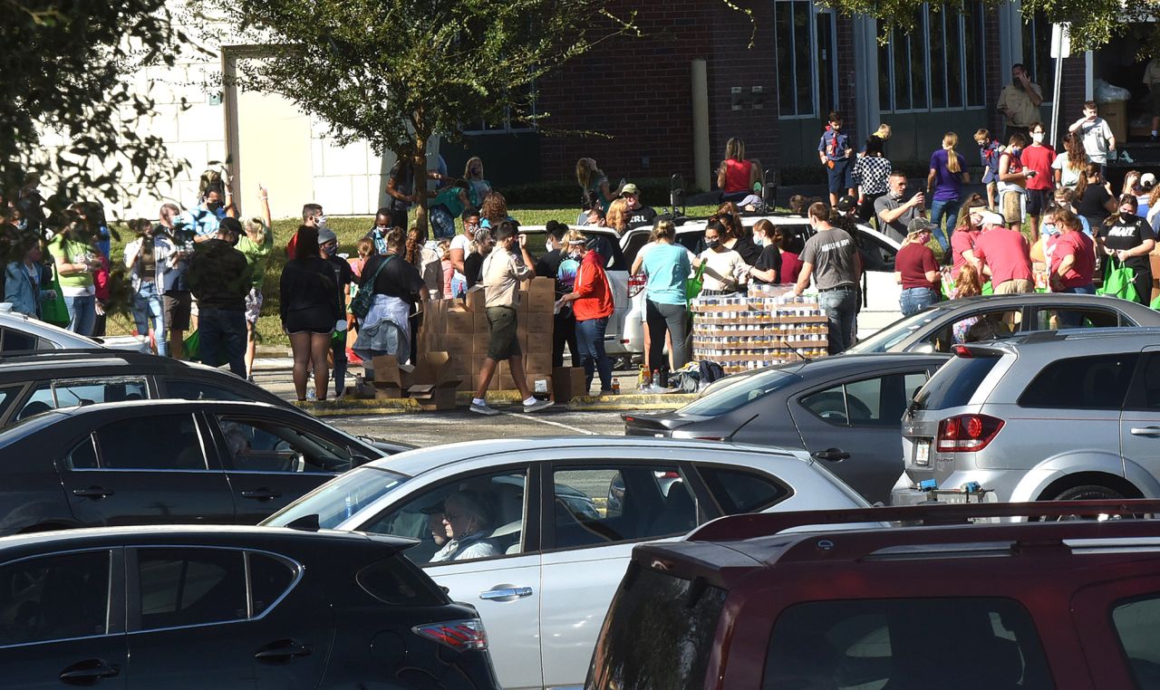 Cars line up at a food distribution site sponsored by local churches and the Second Harvest Food Bank of Central Florida.