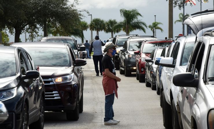 Volunteers direct traffic at a food distribution site in Clermont, Florida.