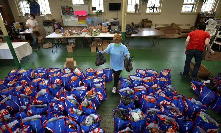 Paulina Bastidas-Yale helps distribute food at a Boston church in September.