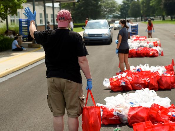Volunteer Joseph Cunliffe holds a bag of bread to put in someone's car in Robesonia, Pennsylvania, in August.