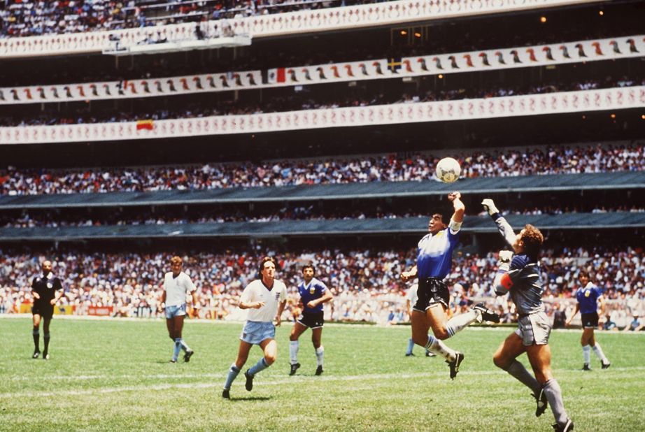 During the quarterfinals of the 1986 World Cup, Maradona outjumps England goalkeeper Peter Shilton to score. The ball went in off Maradona's hand and should have been disallowed, but the officials missed the call. It is now known as the "Hand of God" goal after Maradona said he hit the ball a little with his head "and a little with the hand of God."