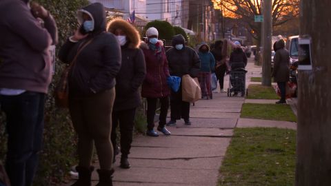 People wait in line to pick up food at Agatha House Foundation in the Bronx.