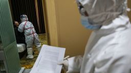 This photo taken on February 4, 2020 shows a medical staff member (L) taking samples from a person to be tested for the new coronavirus at a quarantine zone in Wuhan, the epicentre of the outbreak, in China's central Hubei province. - The world has a "window of opportunity" to halt the spread of a deadly new virus, global health experts said, as the number of people infected in China jumped to 24,000 and millions more were ordered to stay indoors. (Photo by STR / AFP) / China OUT (Photo by STR/AFP via Getty Images)