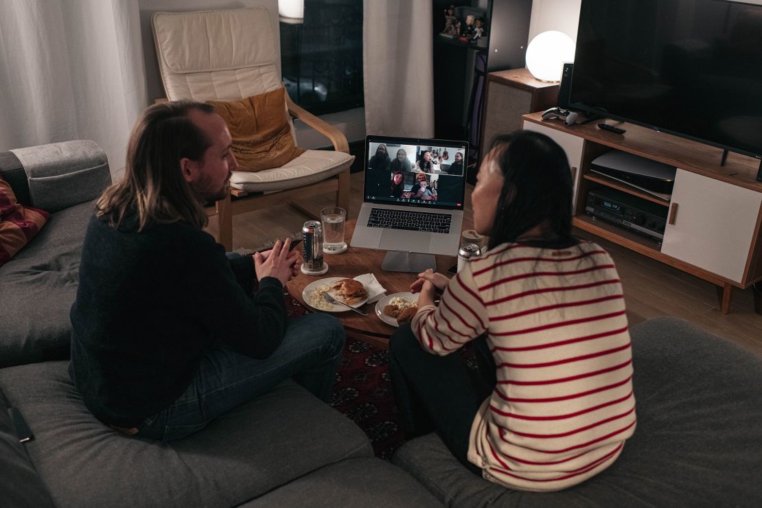 A couple celebrates Thanksgiving with friends by having dinner together over a Zoom video call November 22 in New York.