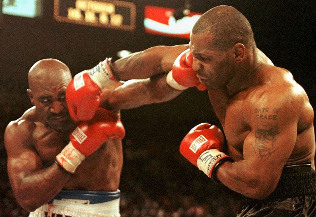 Evander Holyfield (L) and Mike Tyson (R) trade punches on June 28, 1997 in their WBA heavyweight Championship fight at the MGM Grand Garden Arena in Las Vegas.