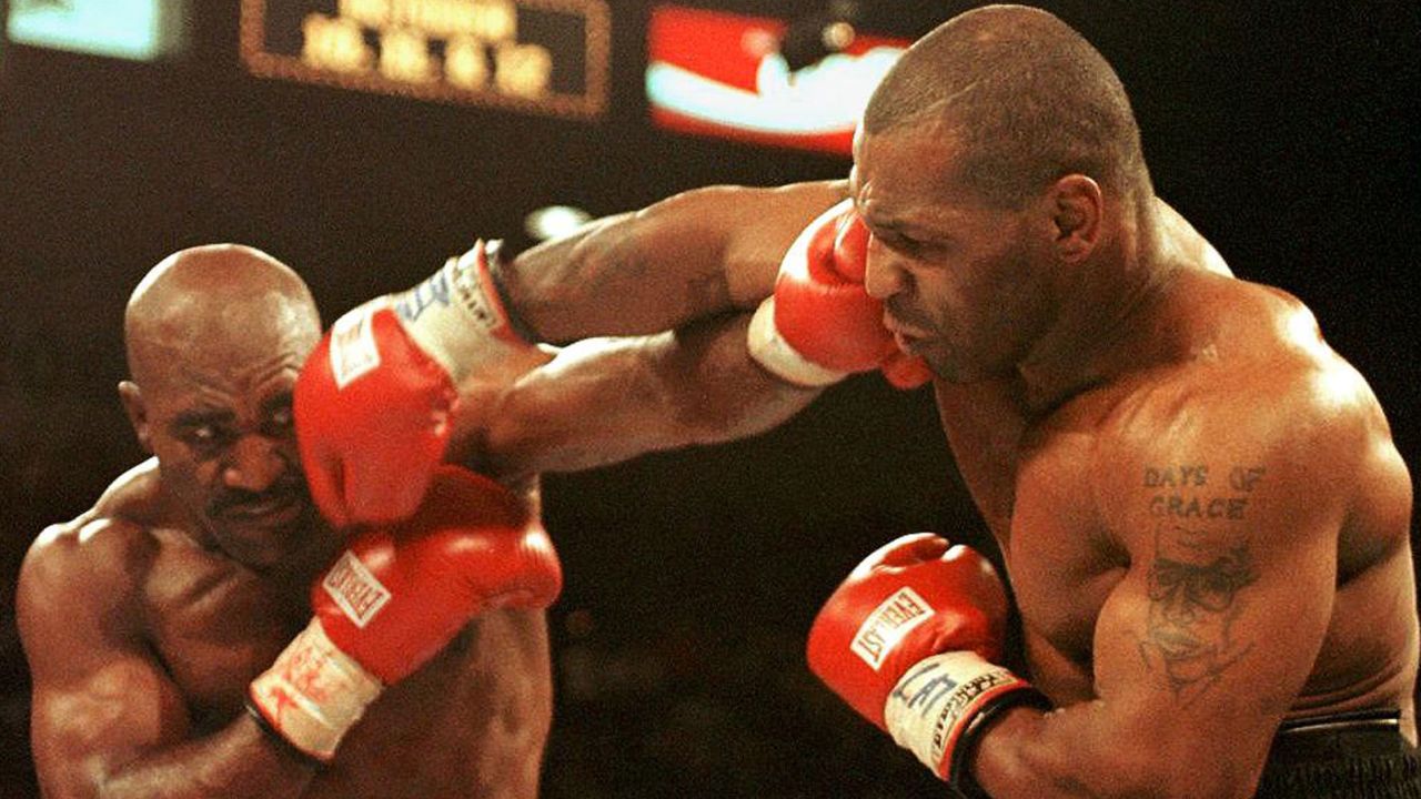 Evander Holyfield (L) and Mike Tyson (R) trade punches on June 28, 1997 in their WBA heavyweight Championship fight at the MGM Grand Garden Arena in Las Vegas.